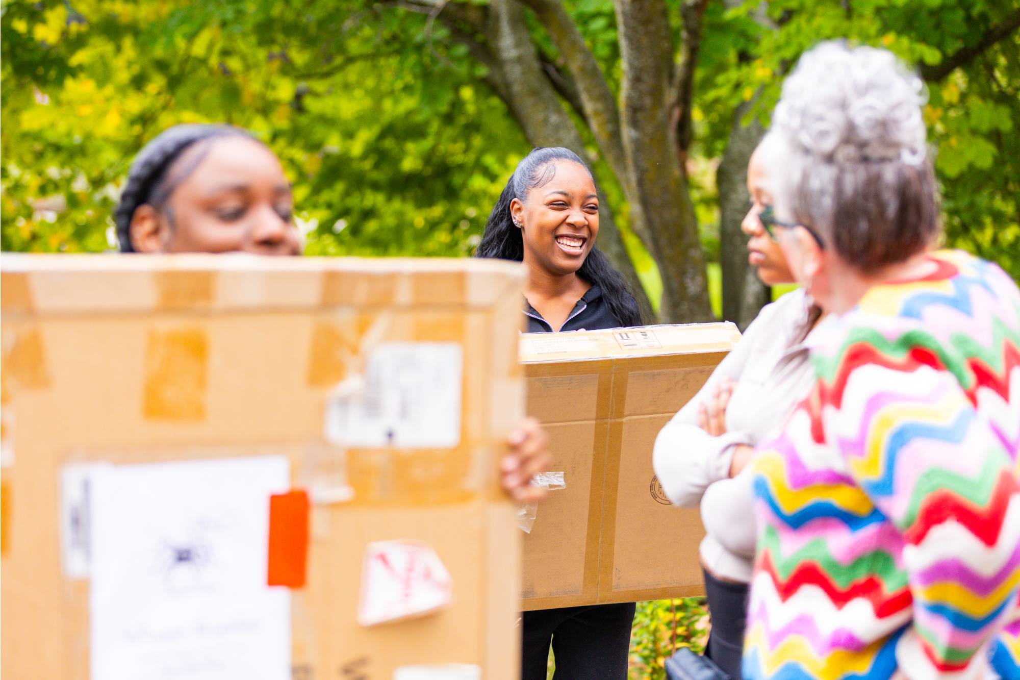 girls carrying boxes